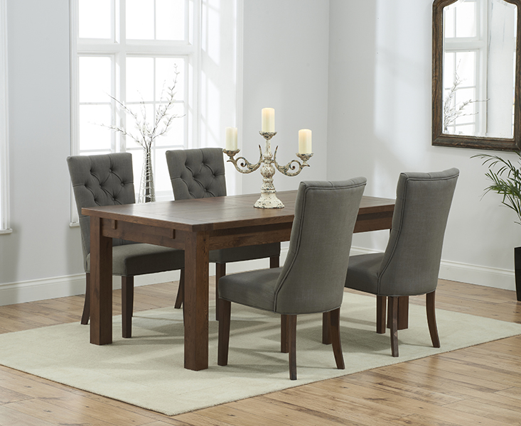Photo 1 of Normandy 150cm dark solid oak extending dining table with 4 grey francois fabric dark oak leg chairs