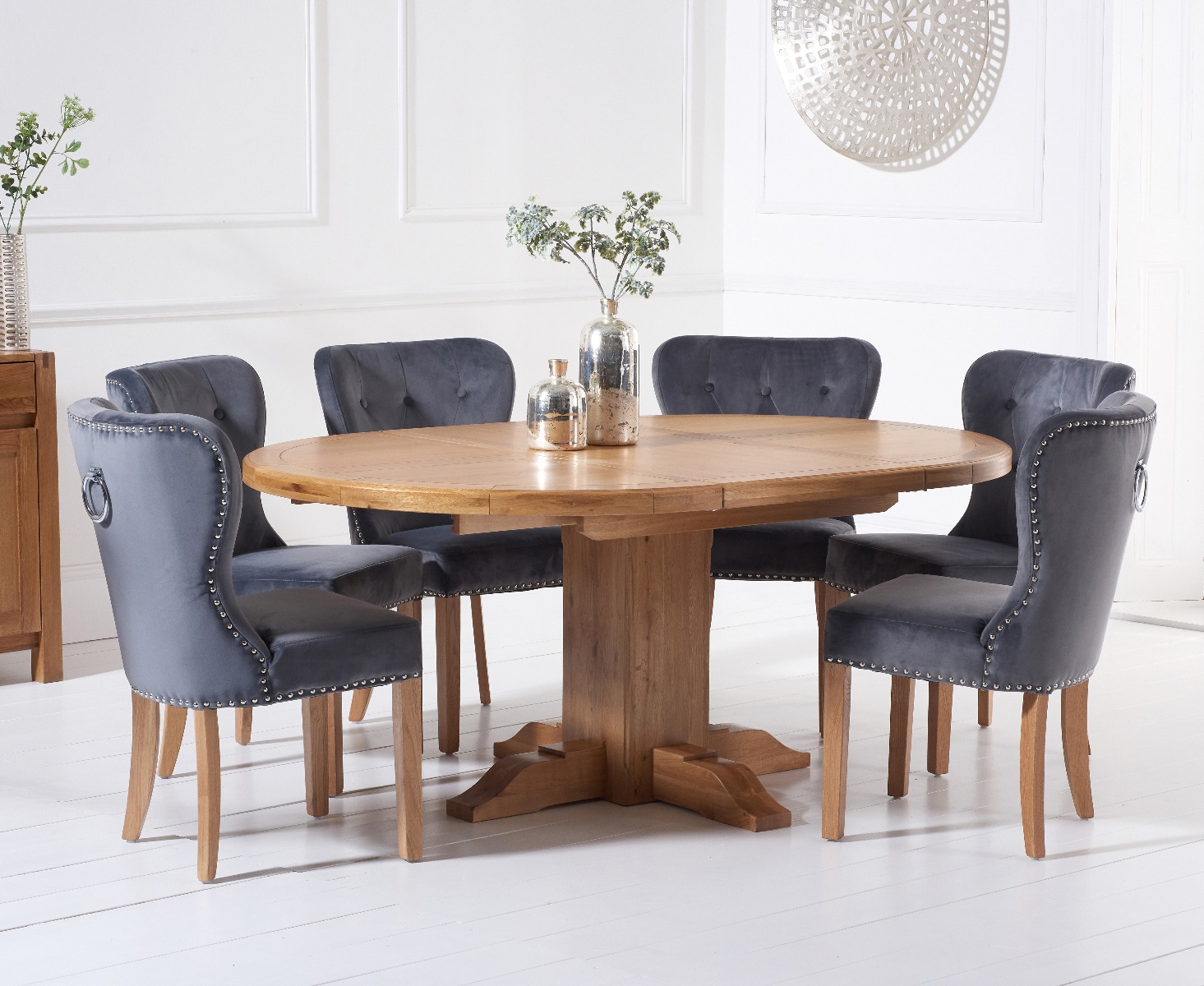 Product photograph of Hemsley Solid Oak Extending Pedestal Dining Table With 6 Grey Keswick Velvet Chairs from Oak Furniture Superstore