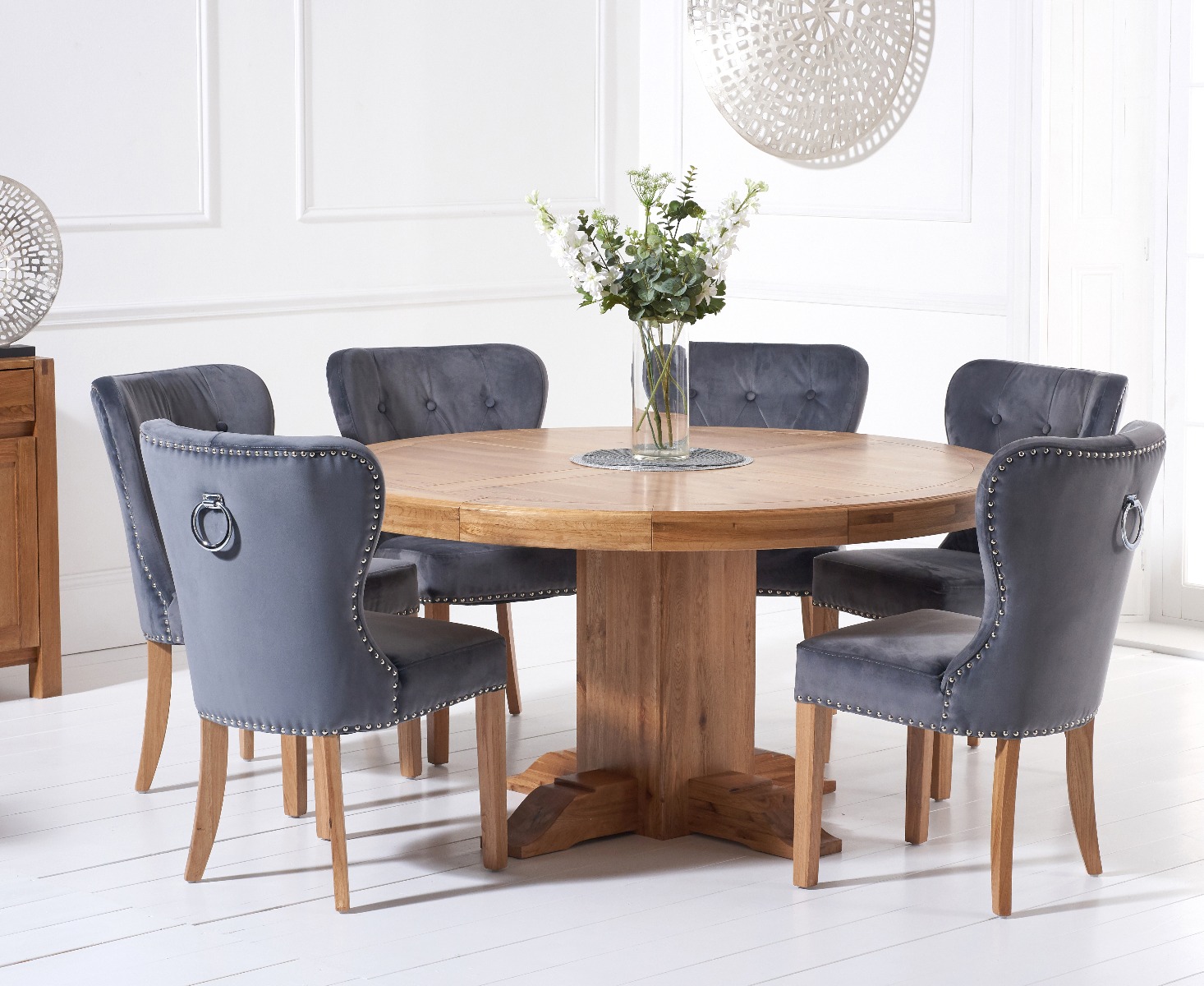 Product photograph of Helmsley 150cm Solid Oak Round Pedestal Dining Table With 4 Grey Keswick Velvet Chairs from Oak Furniture Superstore