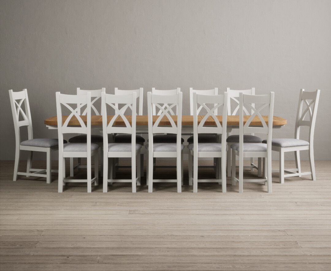 Product photograph of Atlas 180cm Oak And Chalk White Extending Dining Table With 12 Light Grey X Back Chairs from Oak Furniture Superstore
