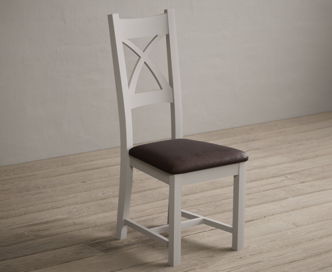 Photo 1 of Painted soft white x back dining chairs with brown suede seat pad