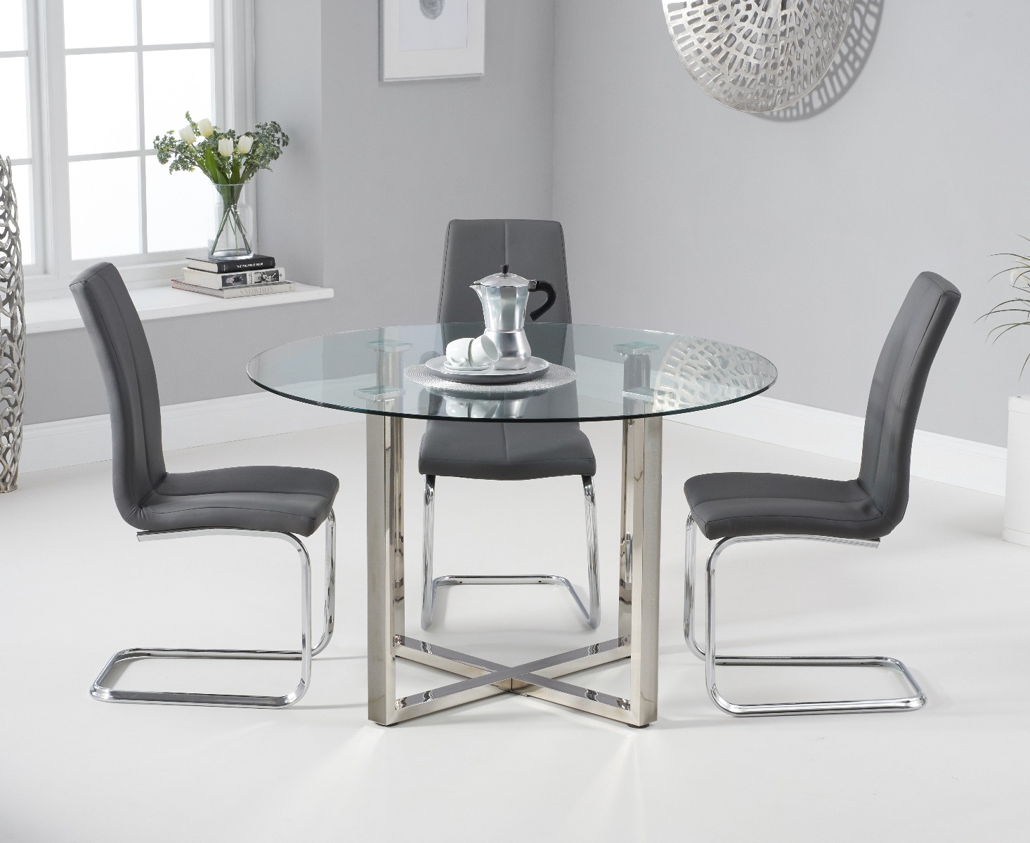 Product photograph of Vaso 120cm Round Glass Dining Table With 4 Grey Gianni Dining Chairs from Oak Furniture Superstore