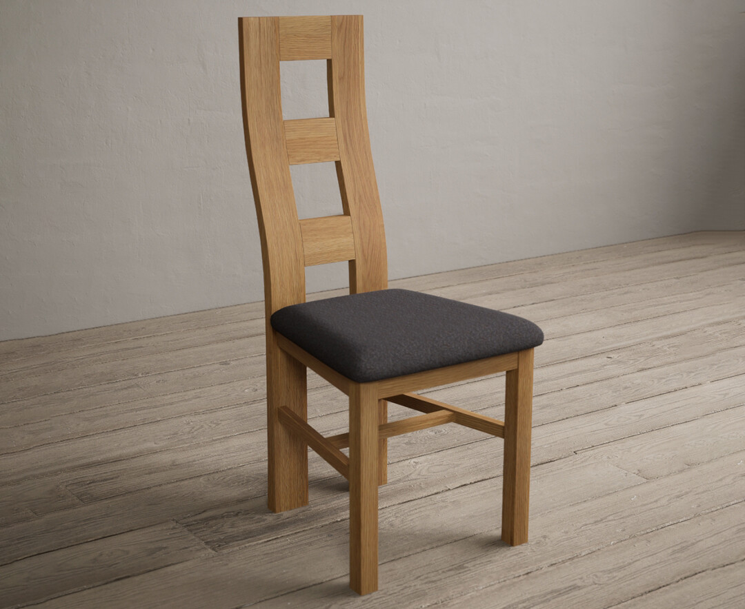 Photo 1 of Natural solid oak flow back dining chairs with charcoal grey fabric seat pad