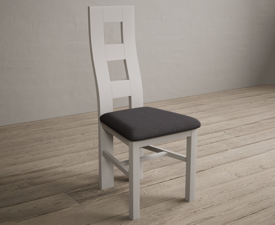 Photo 1 of Painted soft white flow back dining chairs with charcoal grey fabric seat pad